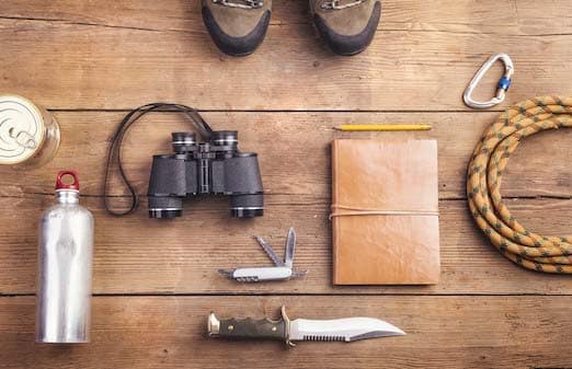 Equipment for hiking on a wooden floor background