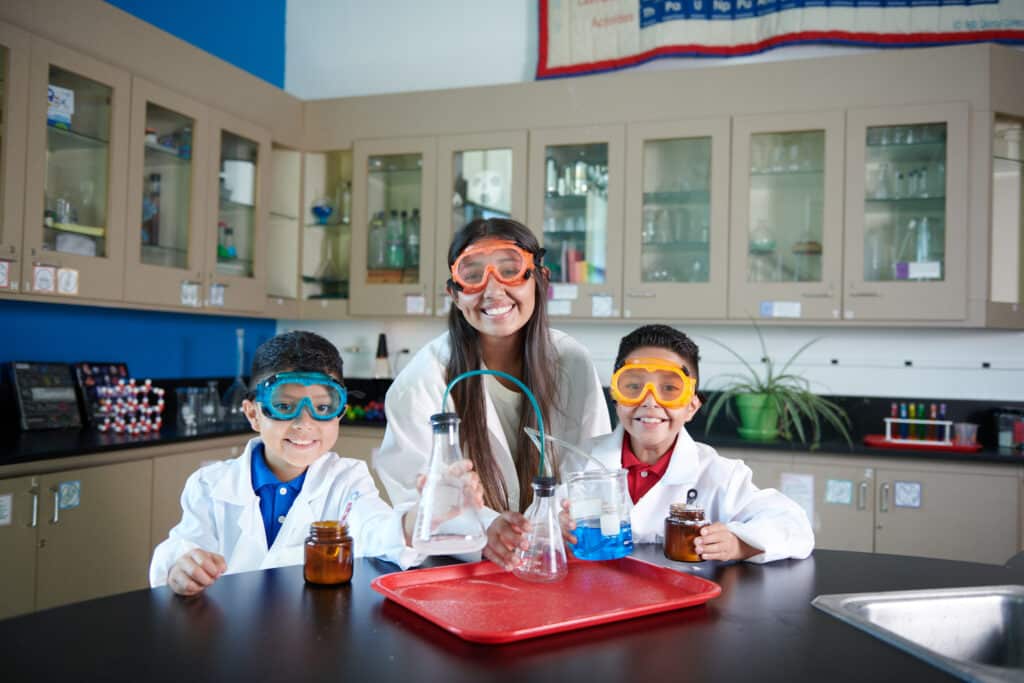 Three kids in the chemistry lab.