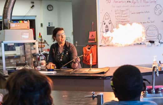 OMSI educator preforming an experiment with fire in the Chemistry Lab. OMSI. July 25, 2019. Portland, OR.