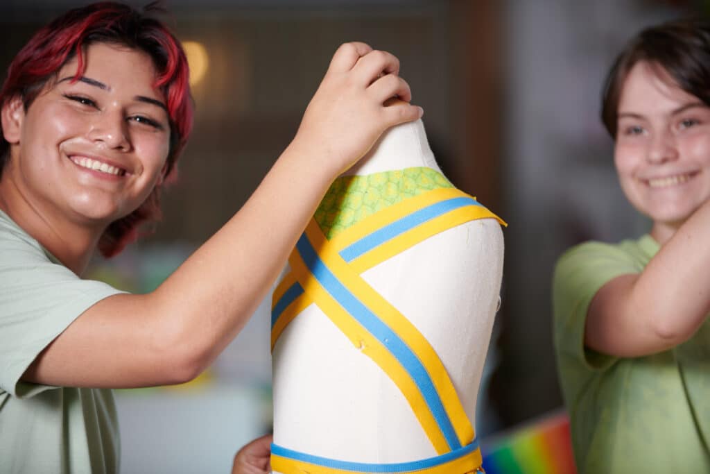 Teen making pattern for clothing in the OMSI Teen Tech Center.