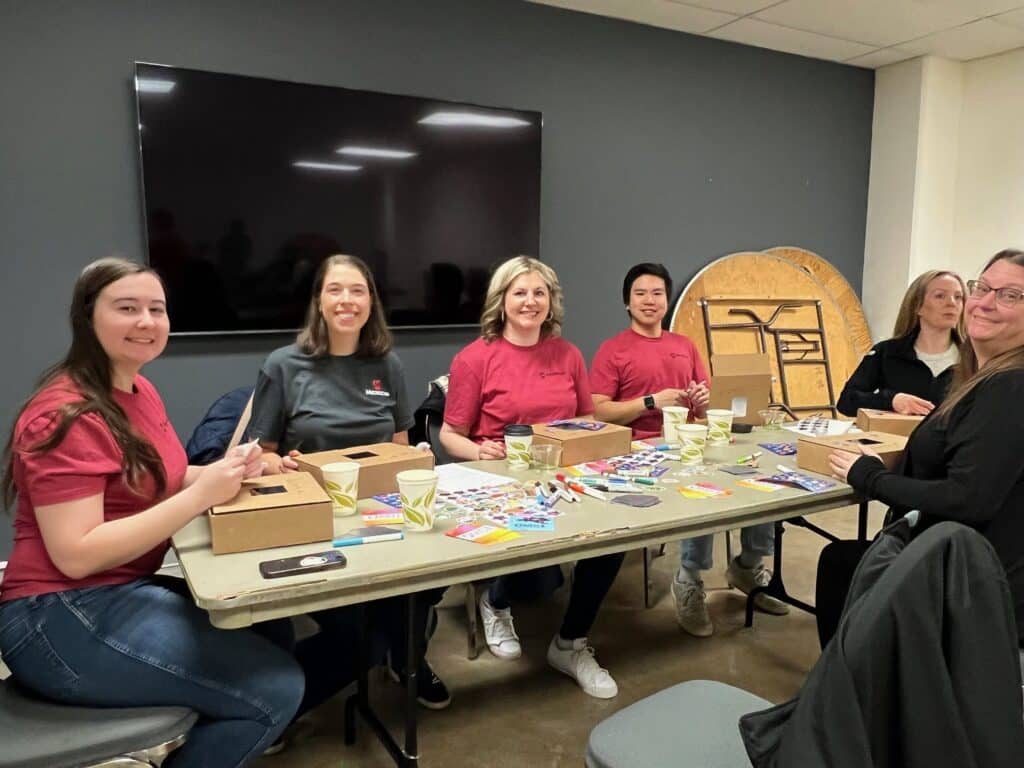 Corporate volunteers assembling STEAM kits for local schools.